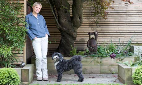 Alice Arnold at home in her garden with her dog