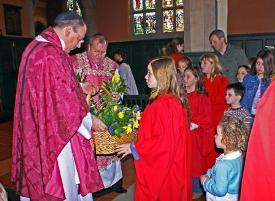 Children distribute flowers on Mothering Sunday